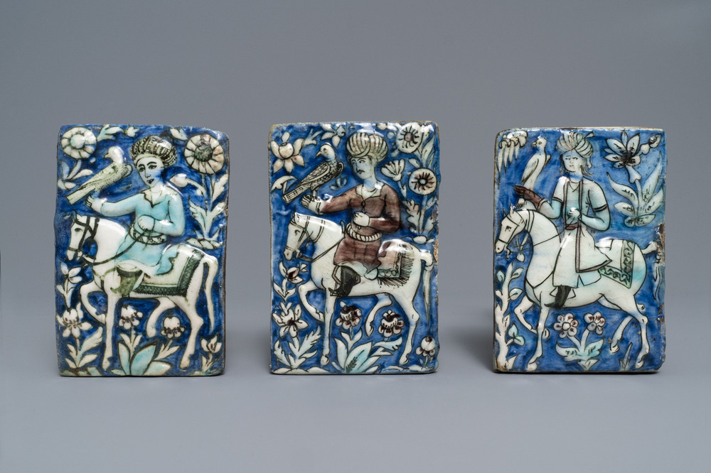 Drie Qajar tegels met reli&euml;fdecor van valkeniers, Iran, 19e eeuw