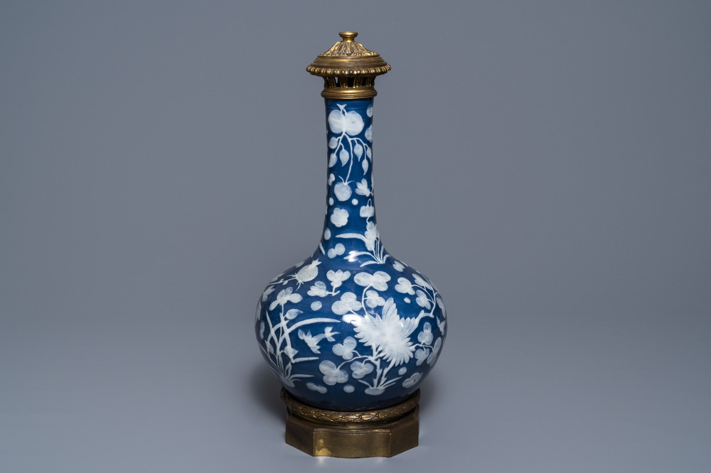 Een Chinese vaas met slibversiering op blauwe fondkleur in verguld bronzen montuur, 19e eeuw