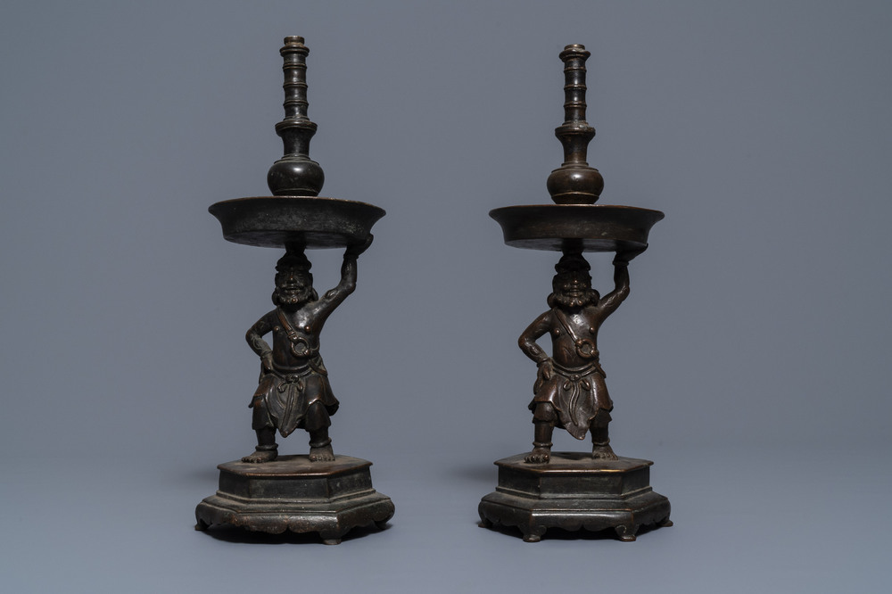 A pair of Chinese bronze candlesticks, Ming