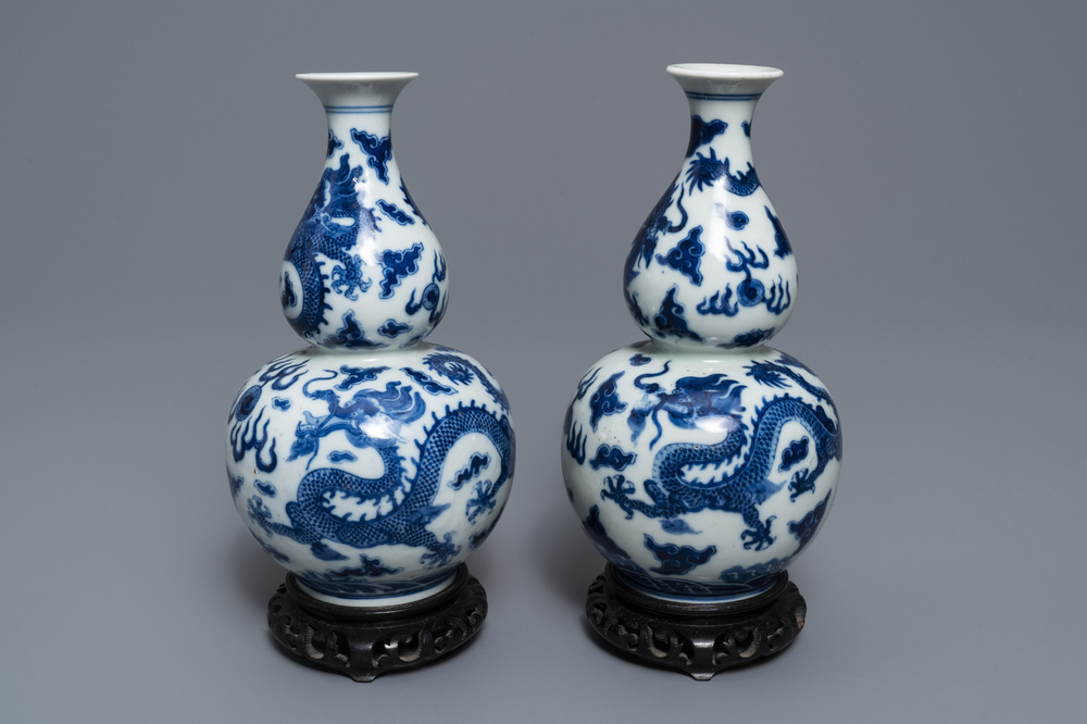 A pair of Chinese blue and white double gourd 'dragon' vases, Qianlong mark, 19th C.