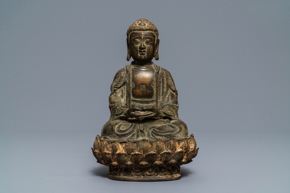 A Chinese bronze figure of Buddha on a lotus throne, Ming