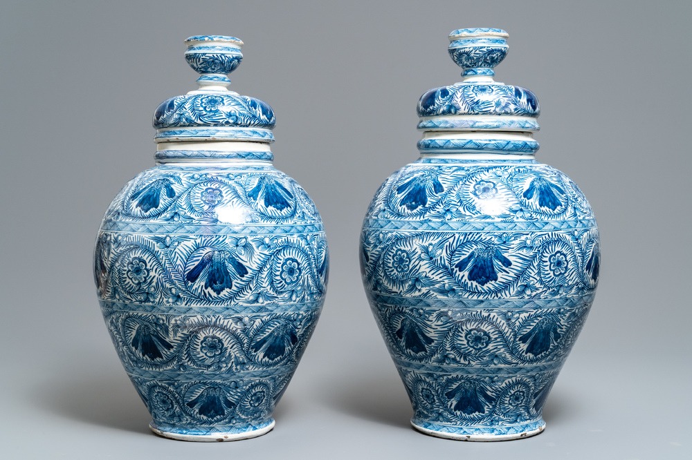 A pair of large Dutch Delft blue and white vases and covers, 18th C.