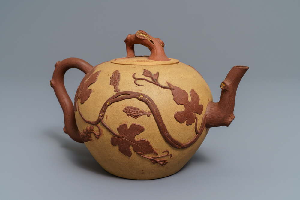 A large Chinese Yixing stoneware teapot with applied grape vines design, Kangxi