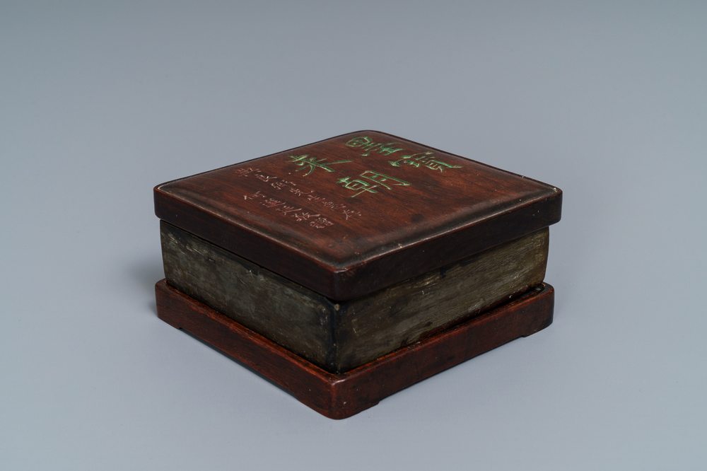 A square Chinese inscribed wood-encased duan inkstone, 19/20th C.