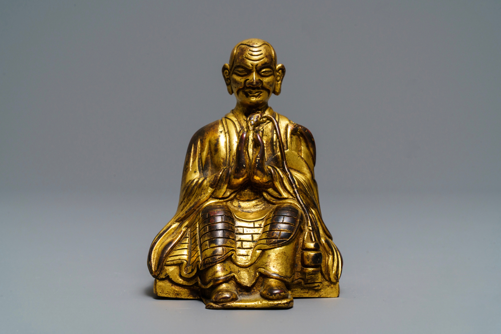 A Sino-Tibetan gilt bronze figure of a Lama, 19th C.