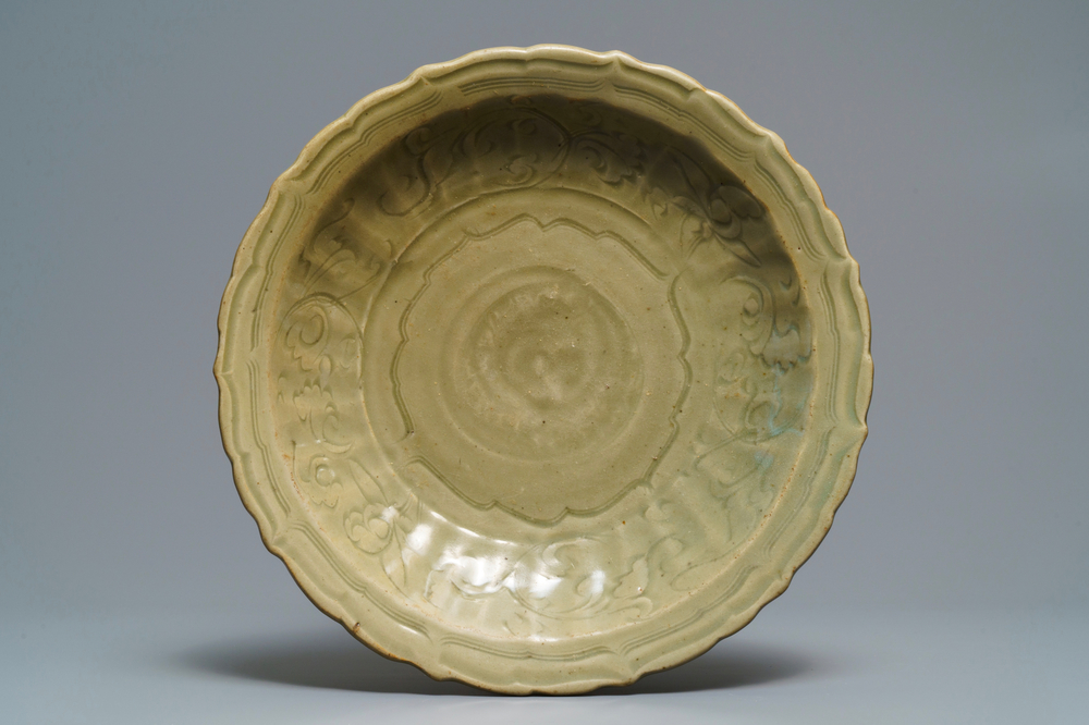 A Chinese Longquan celadon dish with incised floral design, early Ming