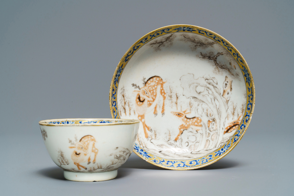 A Chinese grisaille and iron red cup and saucer with deer, Yongzheng/Qianlong