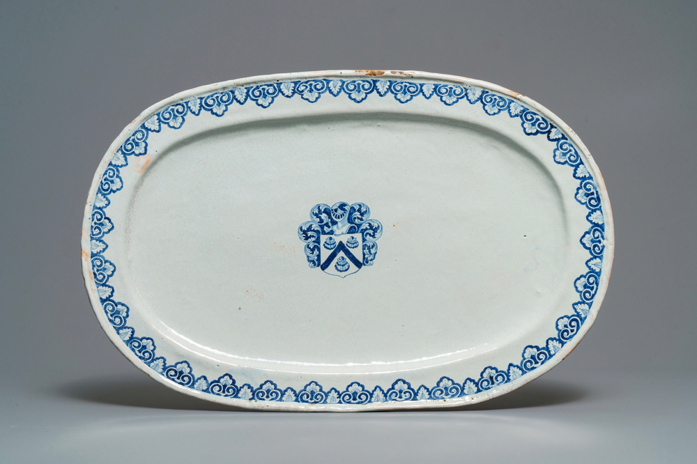 A large blue and white oval French faience dish with the arms of Barres, Rouen, 18th C.