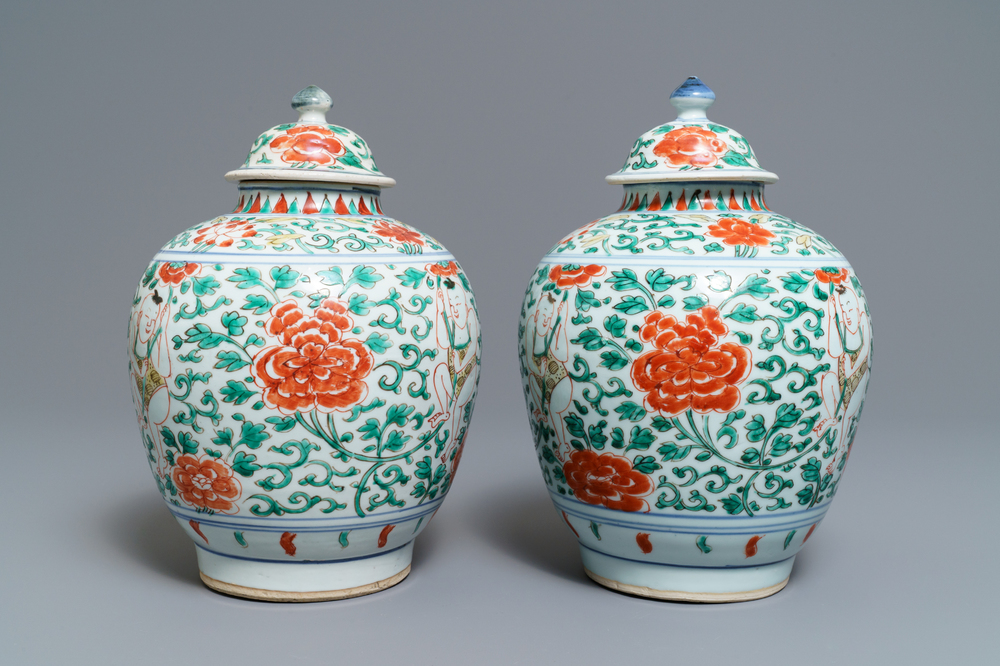 A pair of Chinese wucai vases and covers with boys among peonies, Transitional period