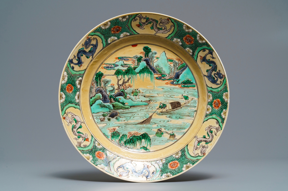 A Chinese famille verte caf&eacute;-au-lait ground plate with fishermen, Kangxi