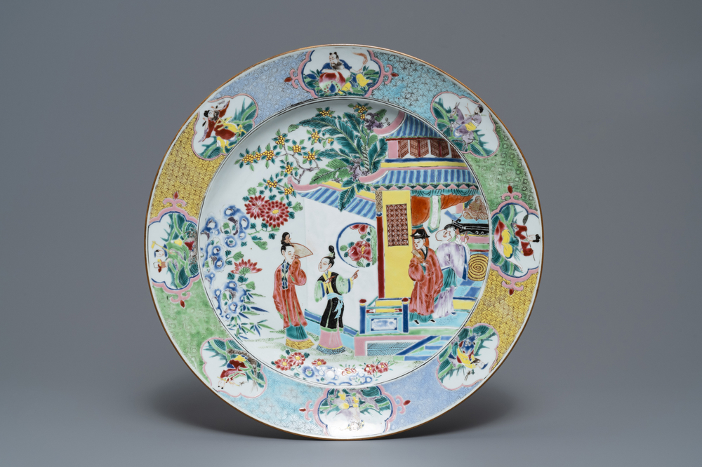 Un grand plat en porcelaine de Chine famille rose &agrave; d&eacute;cor de figures aupr&egrave;s d'un temple, Yongzheng
