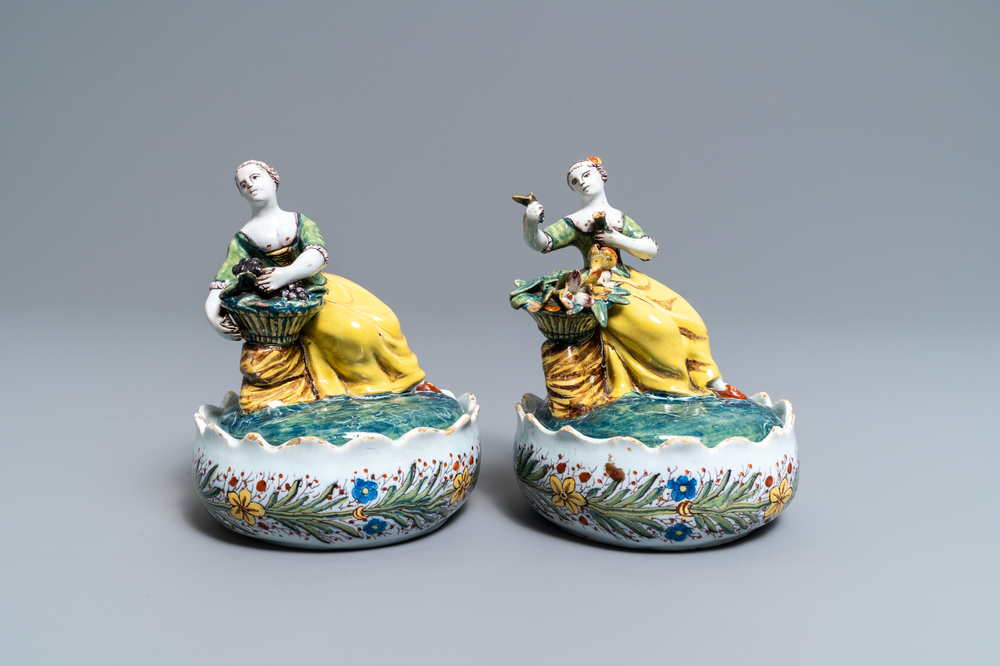 A pair of polychrome Dutch Delft butter tubs with ladies selling flowers and fruits, 18th C.