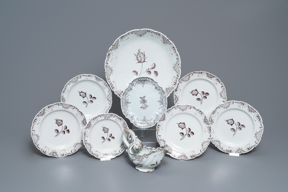 A manganese Dutch Delft part service with a sauce boat on stand, a dish and six plates, 18th C.