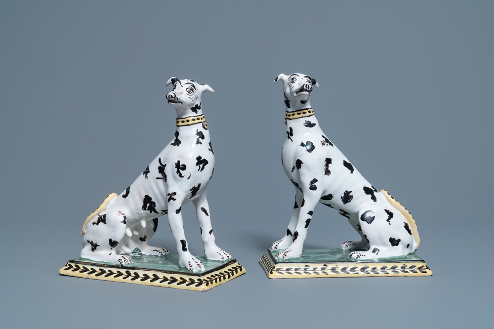 A pair of polychrome Brussels faience models of spotted greyhound dogs, 18th C.