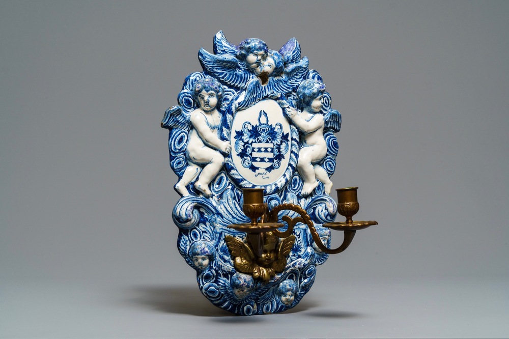 A large Dutch Delft blue and white armorial relief-decorated plaque, early 18th C.