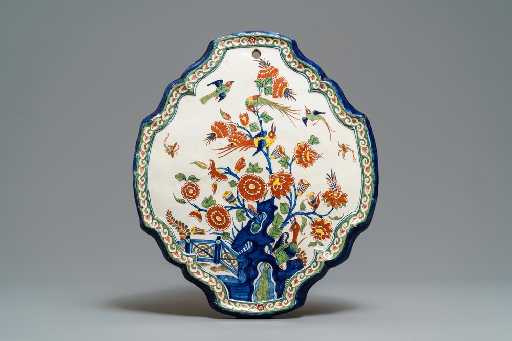 A Dutch Delft cashmere palette plaque with birds and insects among flowers, 18th C.