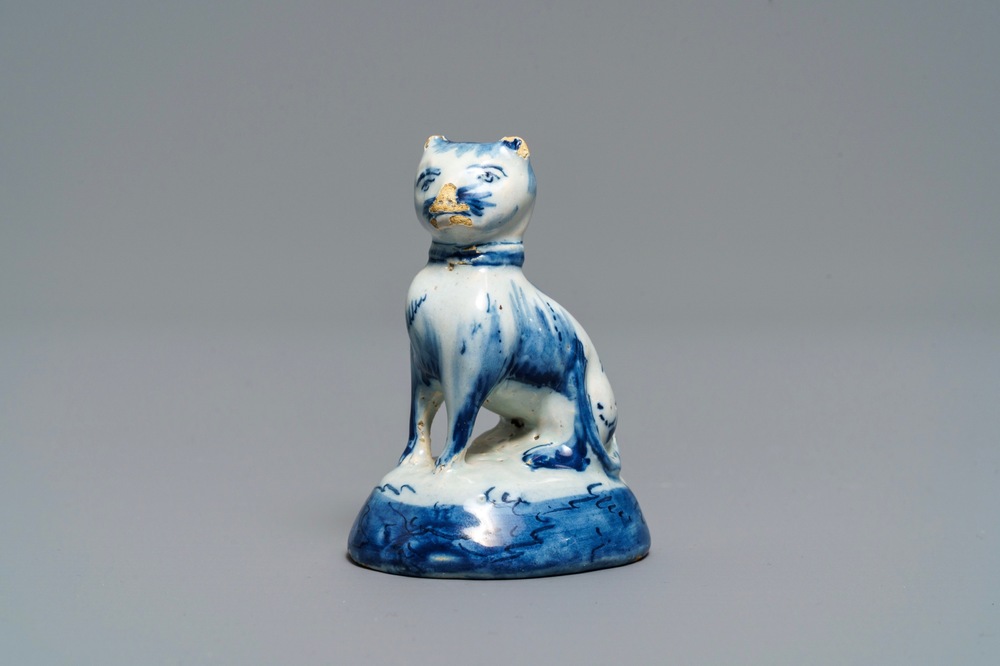 A Dutch Delft blue and white miniature model of a cat, 18th C.