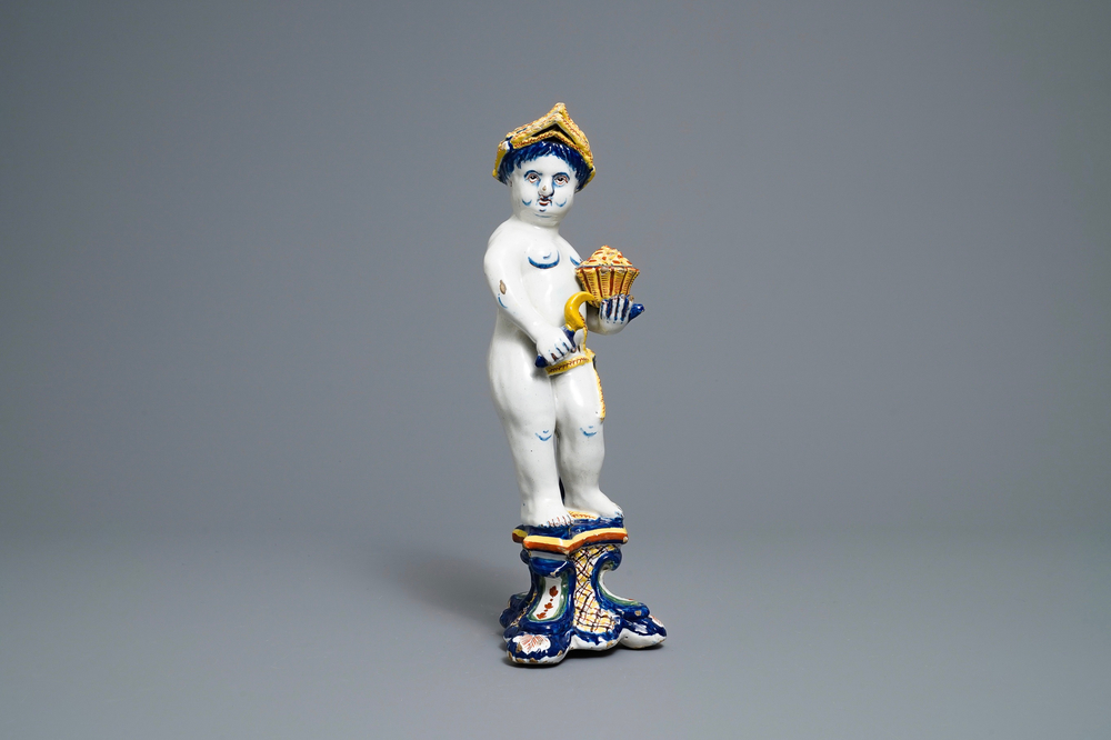 A polychrome Dutch Delft model of a boy, allegory of spring, 18th C.