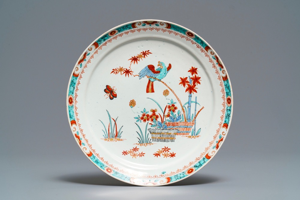 A Dutch Delft dor&eacute; Kakiemon-style plate with a parrot, early 18th C.