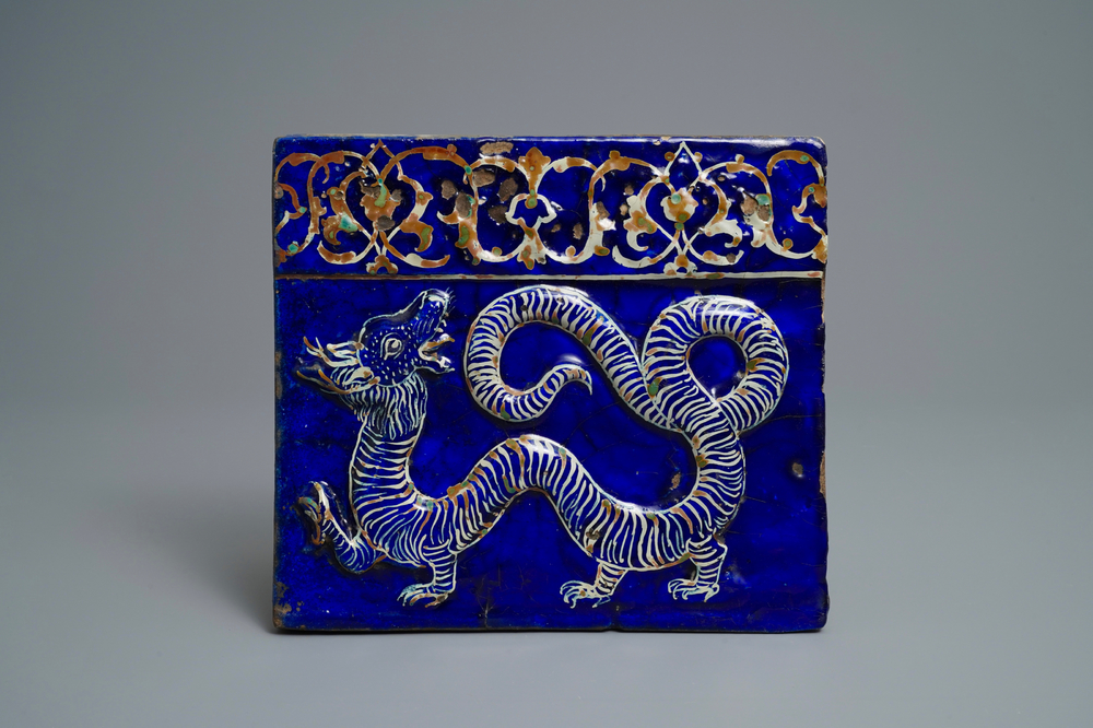 A rare Persian pottery relief-moulded dragon tile, Qajar, Iran, 19th C.