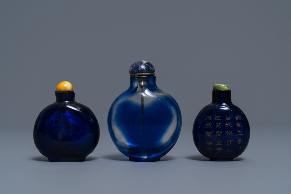 Three Chinese transparent blue glass snuff bottles, one inscribed, 18/19th C.