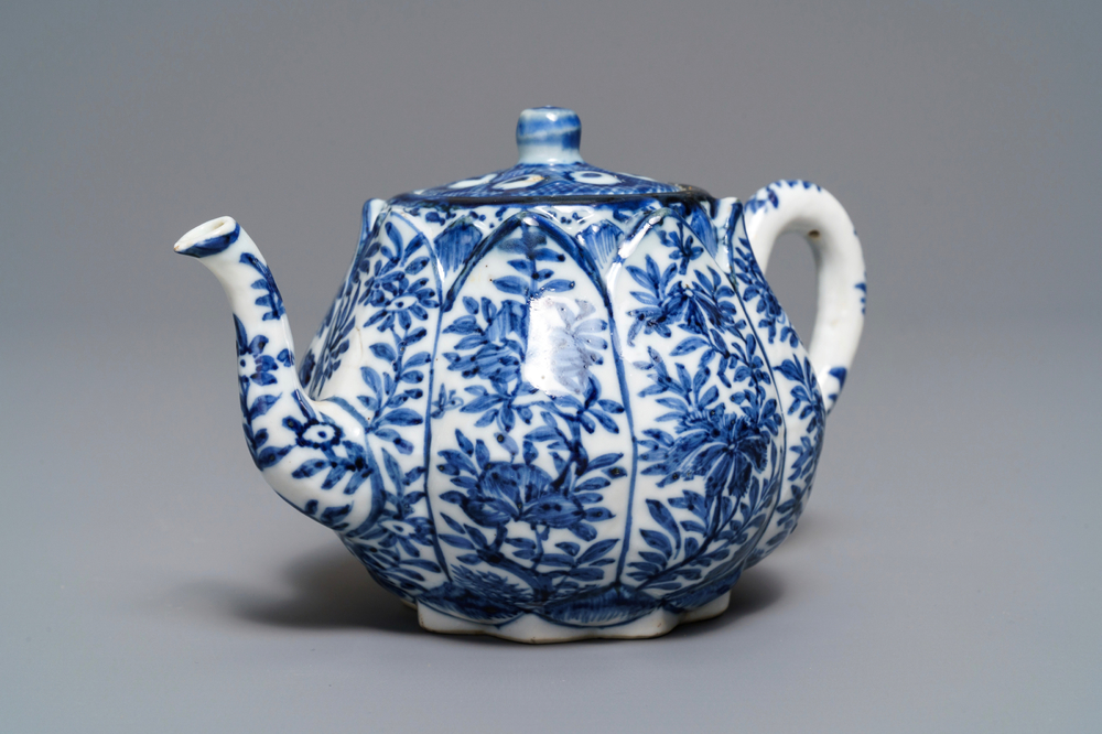 A Chinese blue and white relief-moulded 'lotus flower' teapot and cover, Kangxi