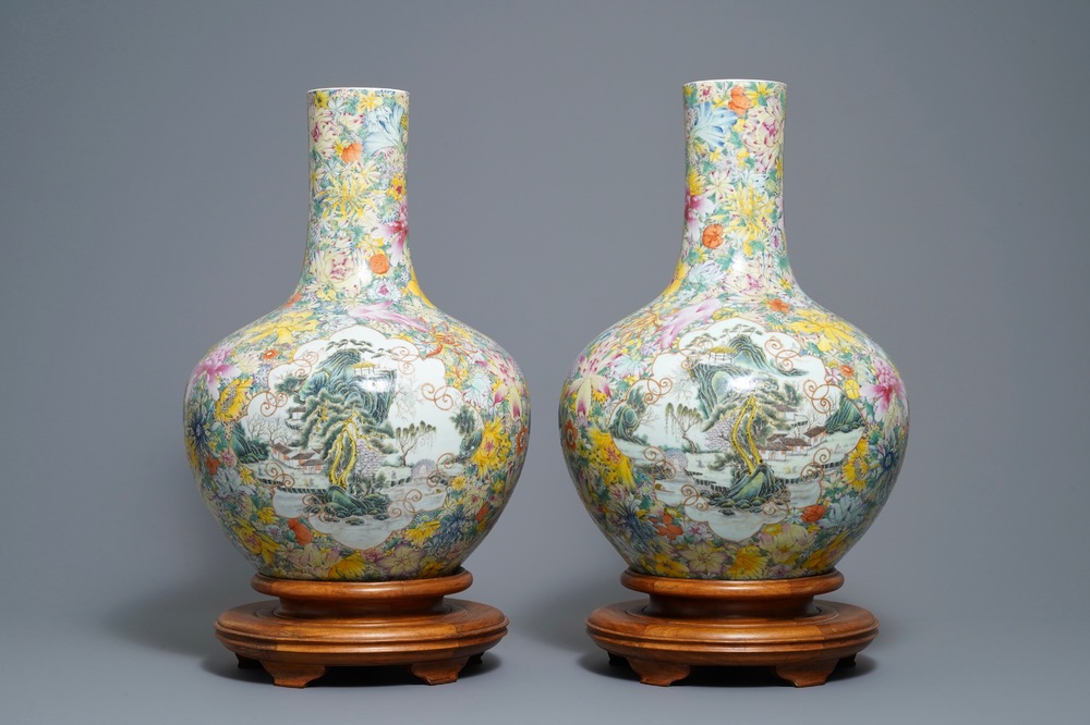 A pair of Chinese famille rose millefleurs bottle vases, Qianlong mark, 19/20th C.