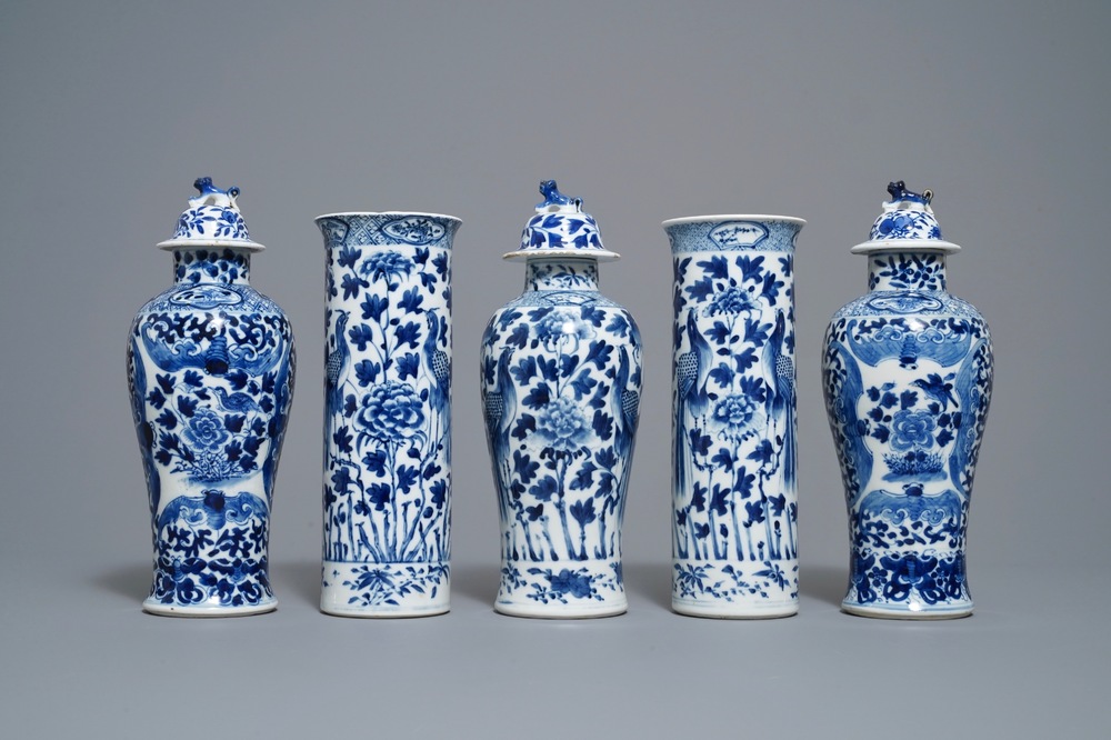 A Chinese blue and white five-piece garniture with peacocks, Kangxi mark, 19th C.