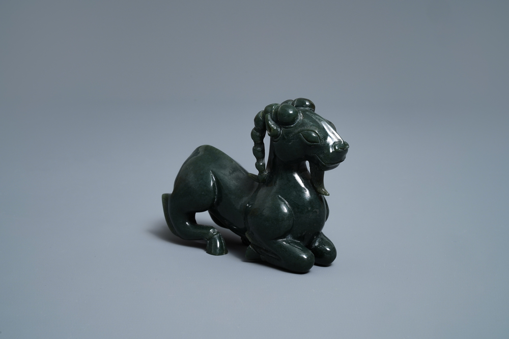 A Chinese spinach green jade model of a recumbent ram, 19/20th C.