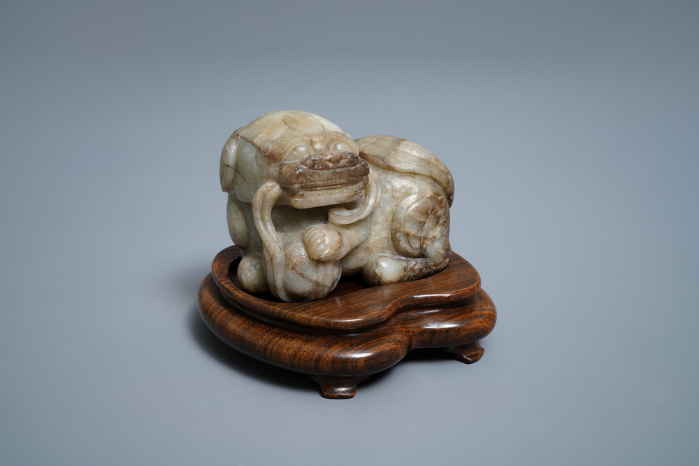 A Chinese pale grey-brown jade model of a Buddhist lion, 19/20th C.