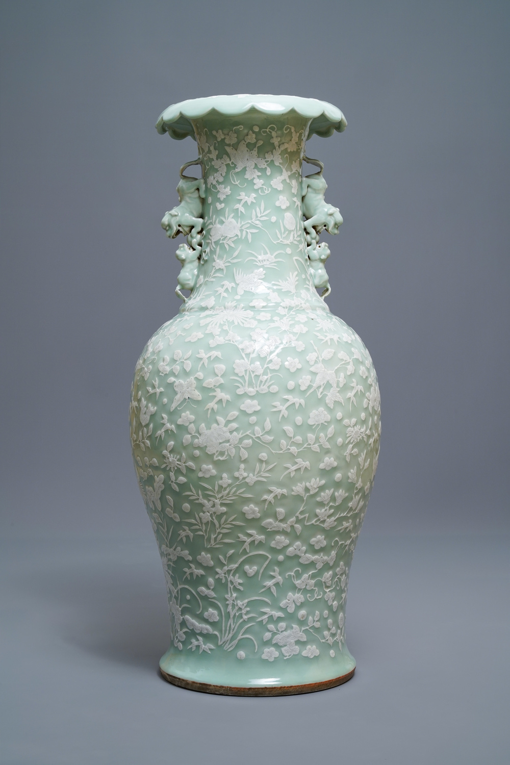 A large Chinese slip-decorated celadon-ground vase, 19th C.