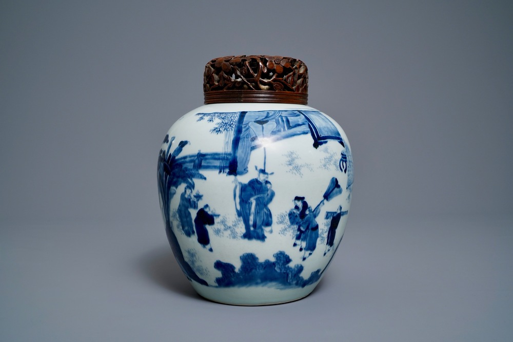 A Chinese blue and white ginger jar with figures in a landscape and a wooden cover, Transitional period