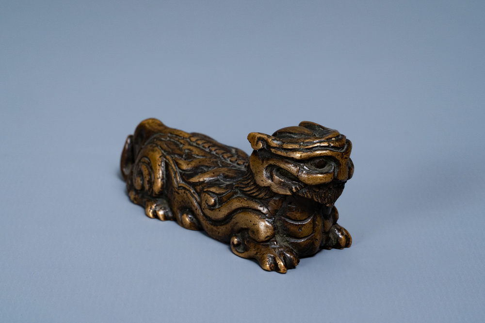 A Chinese bronze 'mythical beast' scroll weight, Ming