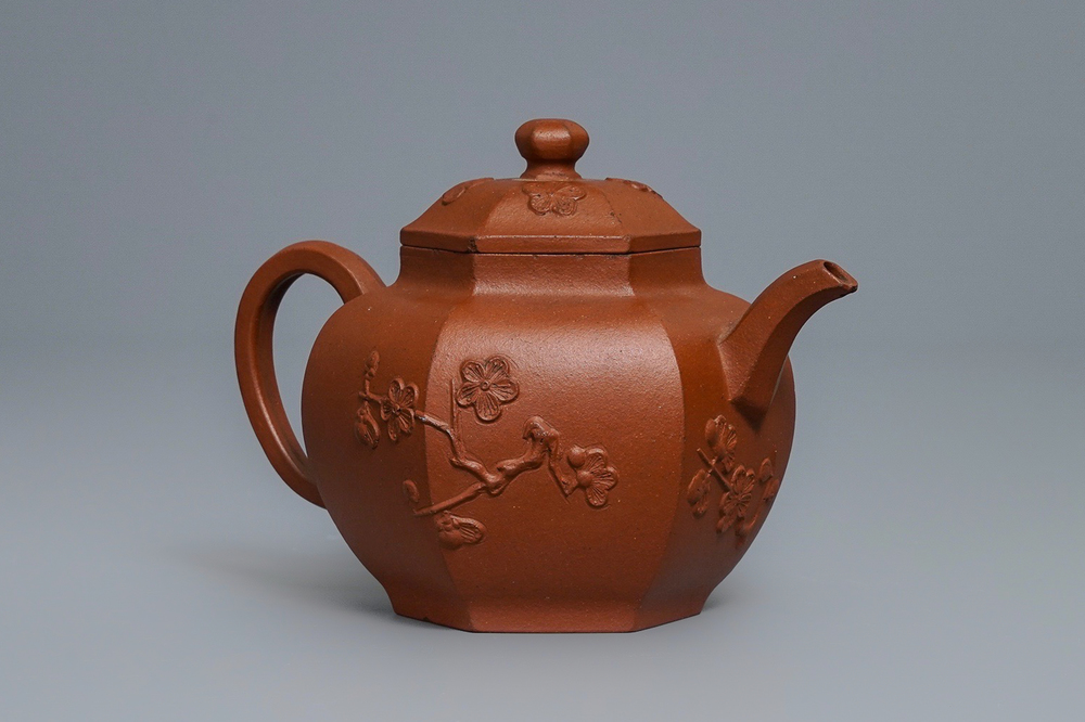 Een Chinese Yixing steengoed theepot met prunus in reli&euml;f, Kangxi