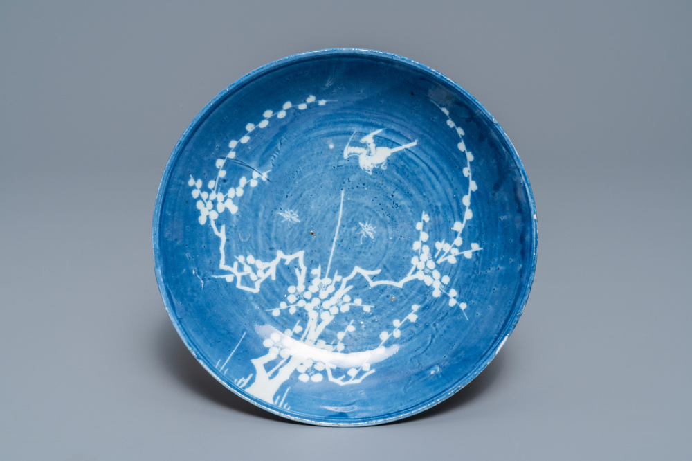 A rare Chinese reverse-decorated 'magpie and prunus' plate, Transitional period