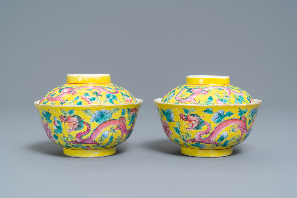 A pair of Chinese yellow-ground famille rose 'dragon and phoenix' bowls and covers, 19th C.