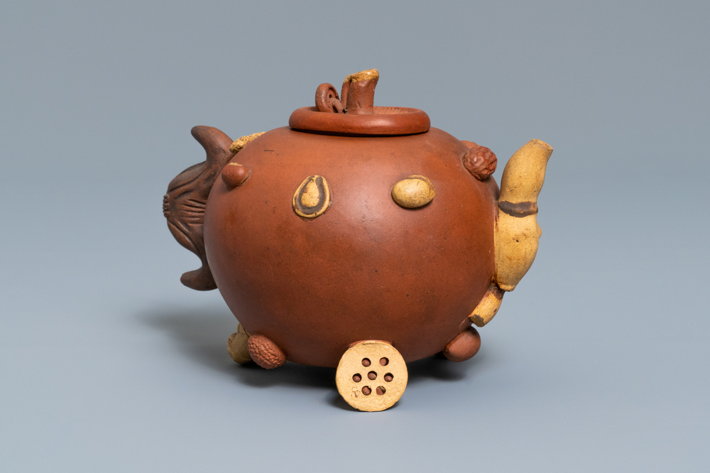 Een Chinese Yixing steengoed theepot met reli&euml;fdecor van vruchten en noten, reli&euml;fmerk, 19e eeuw