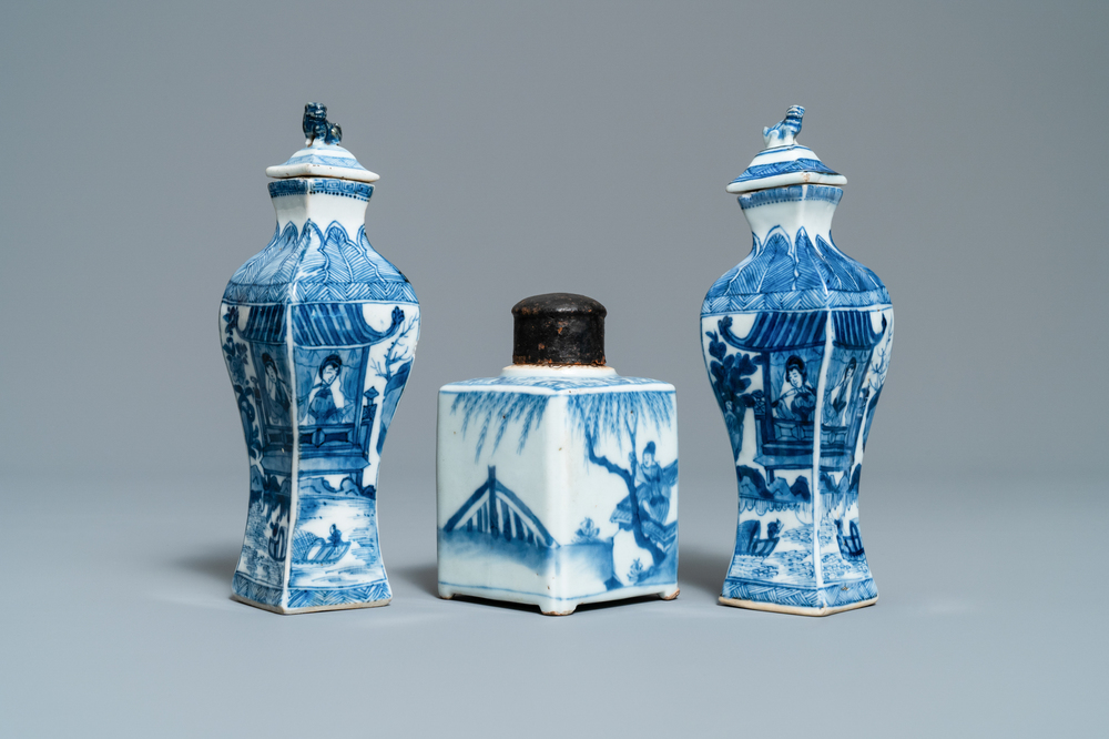 A pair of square Chinese blue and white covered vases and a tea caddy, Kangxi