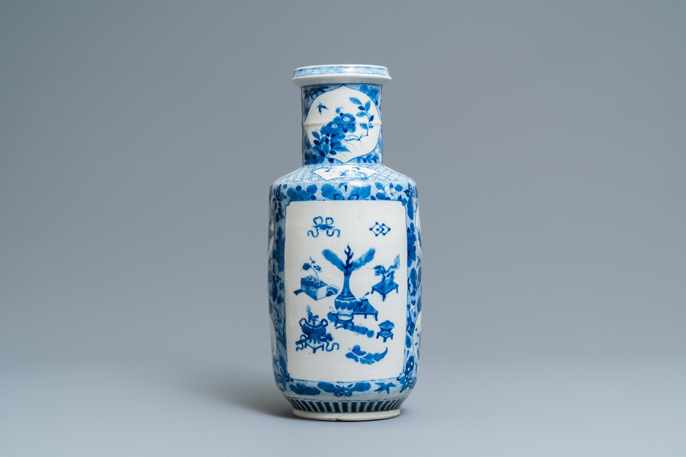 A Chinese blue and white rouleau vase with antiquities and floral designs, 19th C.