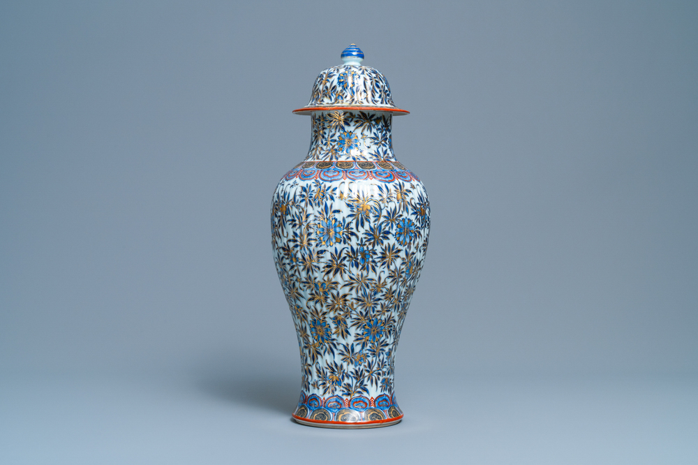 A Chinese blue and white clobbered vase and cover with floral design, Kangxi