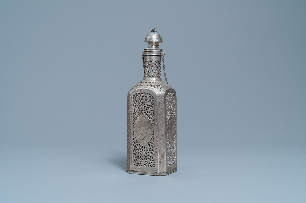 A reticulated Qajar silver flask with glass insert, Iran, 19th C.