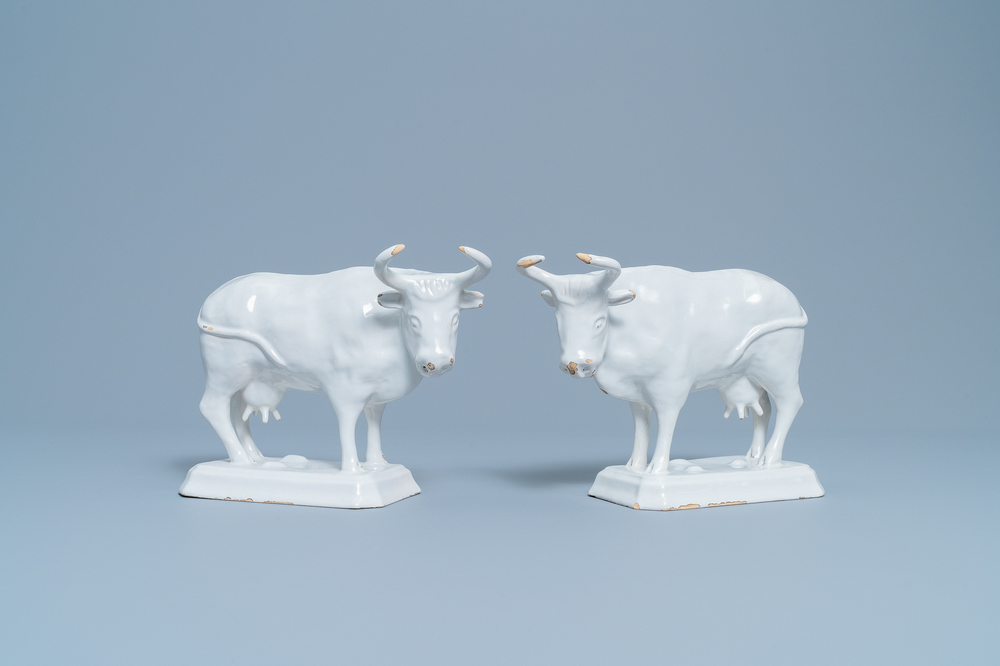 A pair of white Dutch Delftware cows on bases, 18th C.