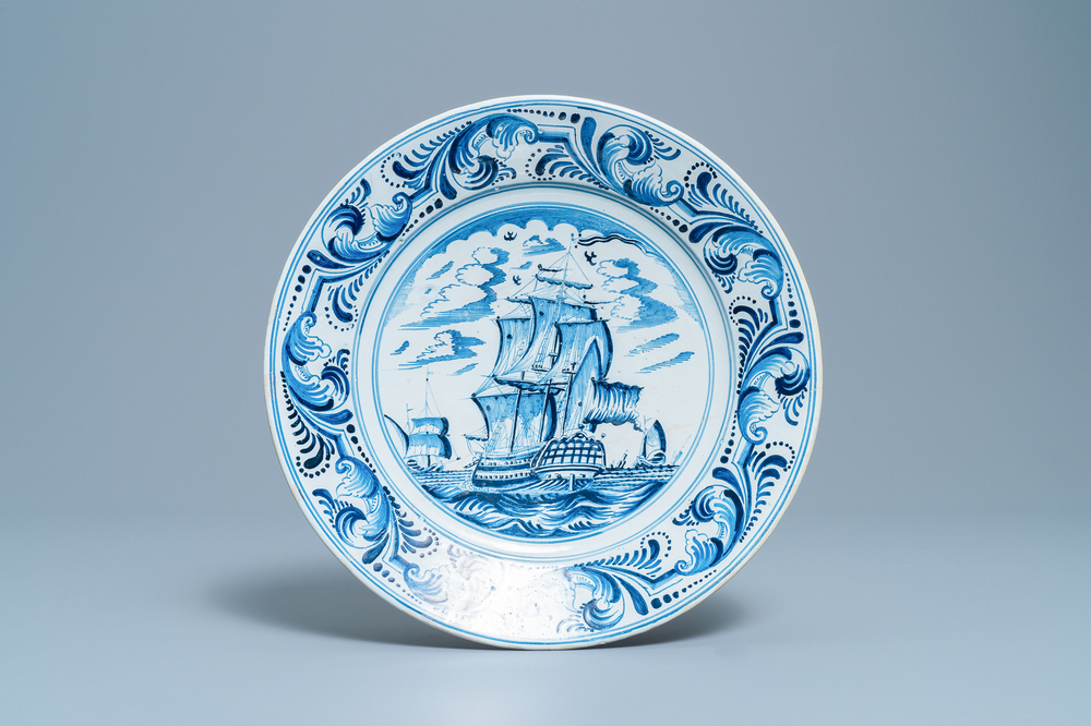 A Dutch Delftware blue and white dish with a large battle ship, Bolsward, Friesland, 18th C.