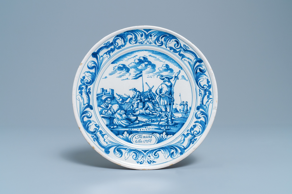Un plat en fa&iuml;ence de Makkum en bleu et blanc &agrave; d&eacute;cor de soldats au camp, la Frise, dat&eacute; 1764