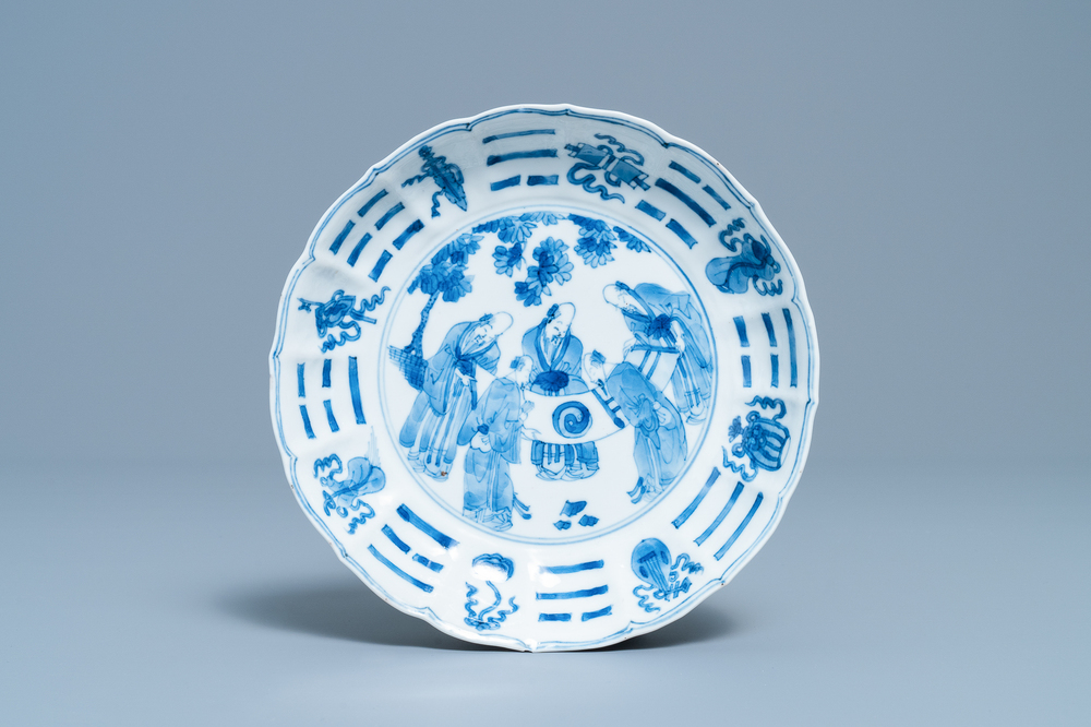 A Chinese blue and white plate with scholars admiring a scroll, Chenghua mark, Kangxi