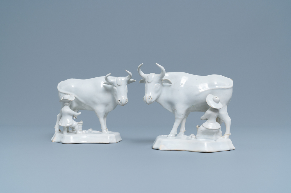 A pair of white Dutch Delftware groups of cows with milkers, 18th C.
