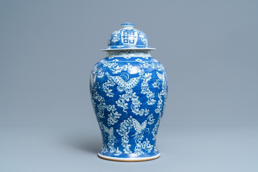 A Chinese blue and white 'butterfly' vase and cover, 19th C.