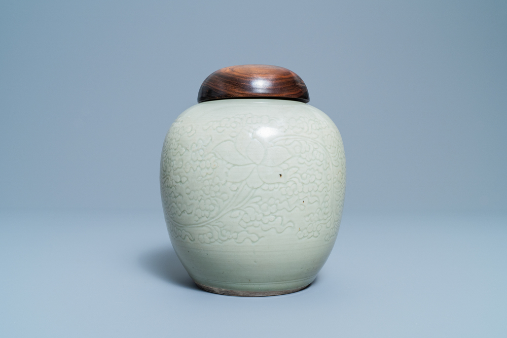 A Chinese monochrome celadon jar with underglaze lotus design, Kangxi