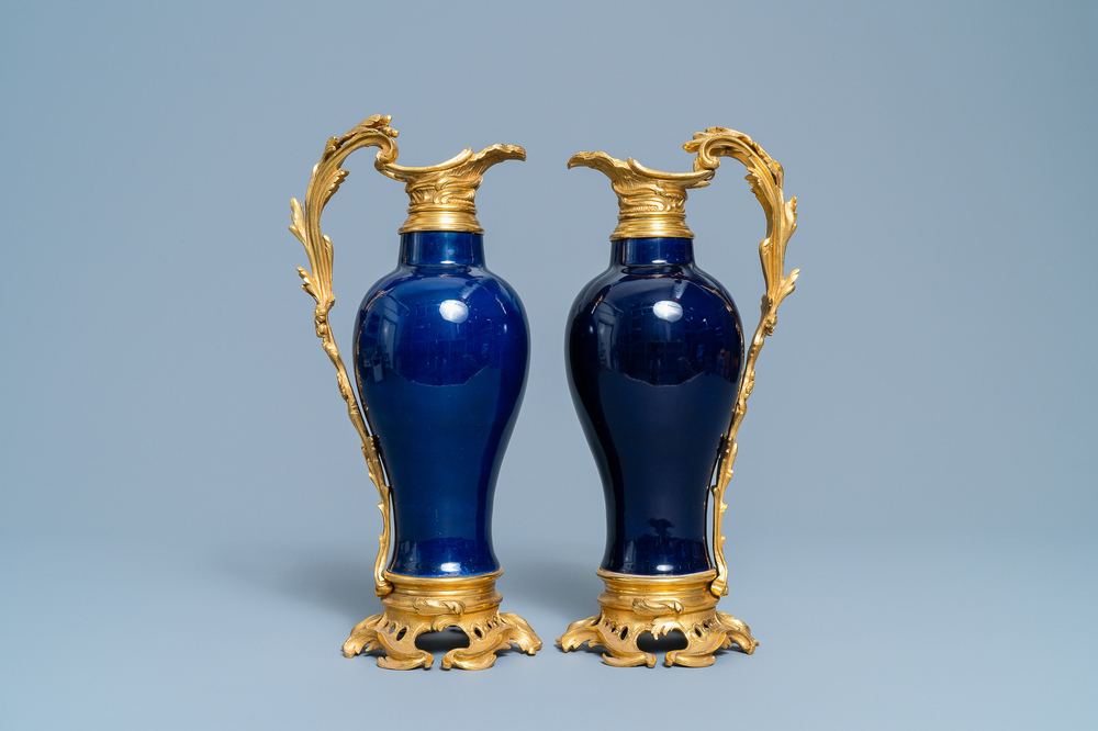 A pair of Chinese gilt bronze ewer-mounted monochrome blue vases, 18/19th C.