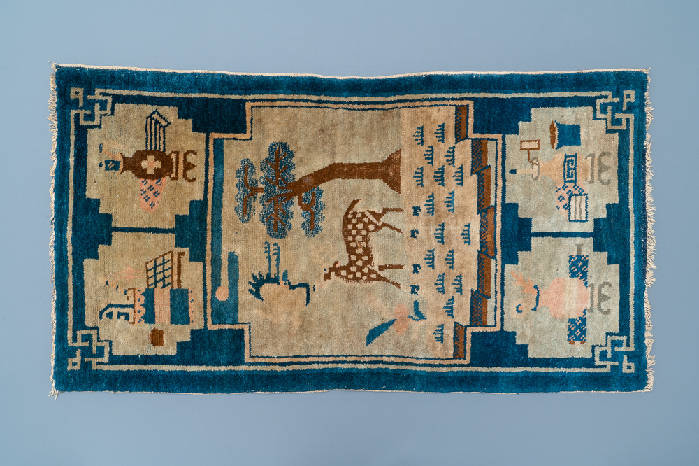 A rectangular Chinese hand-knotted wool carpet with a crane and a deer, 19/20th C.